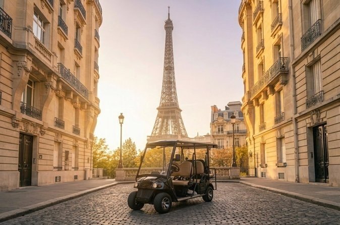 An open golf cart parked on a cobbled Paris street, the Eiffel Tower at the end of the road between stone apartment buildings